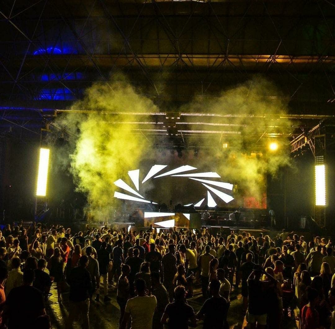 Taj Mahal stage surrounded by yellow smoke and a packed crowd